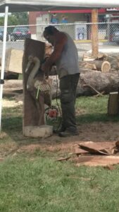 Man Carving a swan out of wood